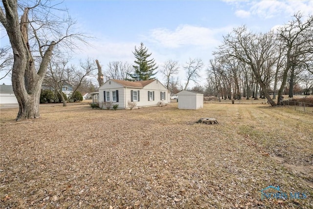 view of front of house with a shed and an outdoor structure