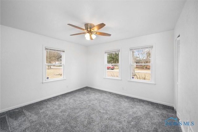 unfurnished room with carpet floors, baseboards, and a ceiling fan