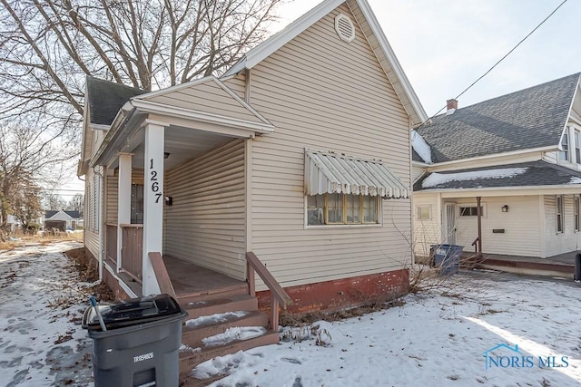 exterior space featuring roof with shingles