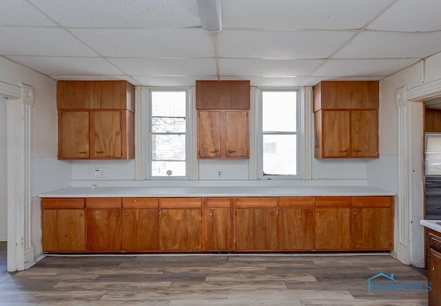 kitchen with dark wood-style floors, light countertops, and brown cabinetry