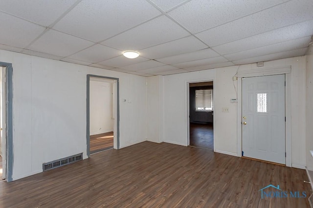 entrance foyer featuring visible vents, a drop ceiling, and wood finished floors