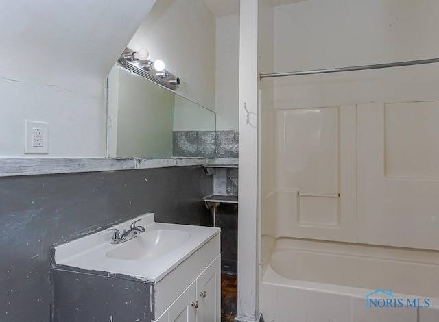 bathroom featuring washtub / shower combination and vanity