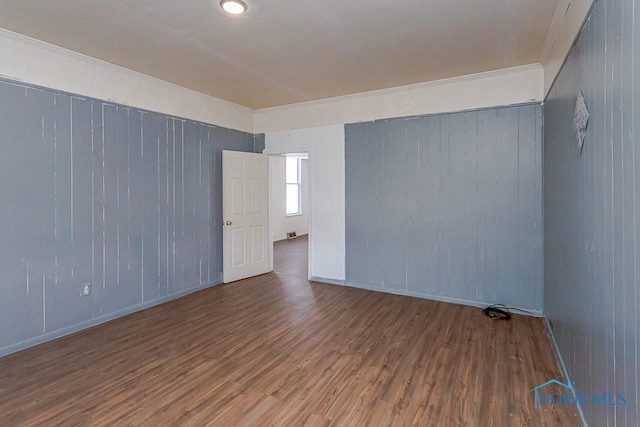 unfurnished room with wood finished floors