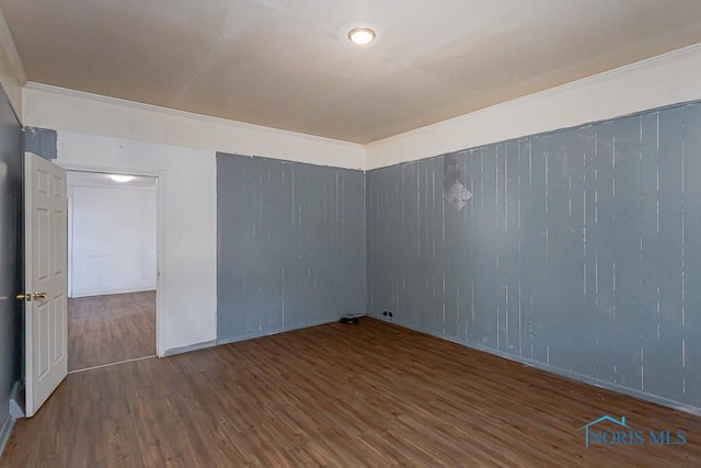 unfurnished room with wood finished floors