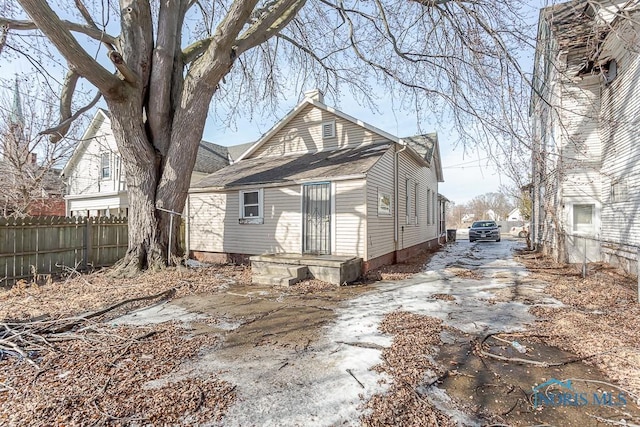 rear view of property with fence