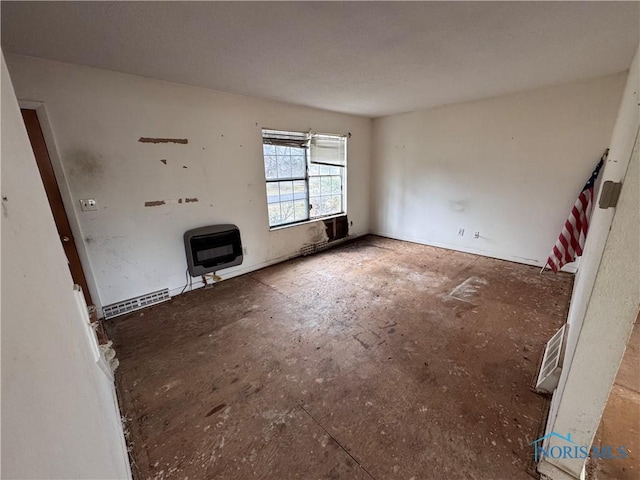 unfurnished living room featuring heating unit