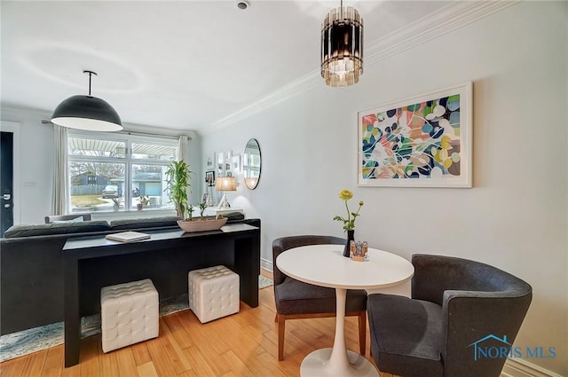 interior space with an inviting chandelier, crown molding, and wood finished floors