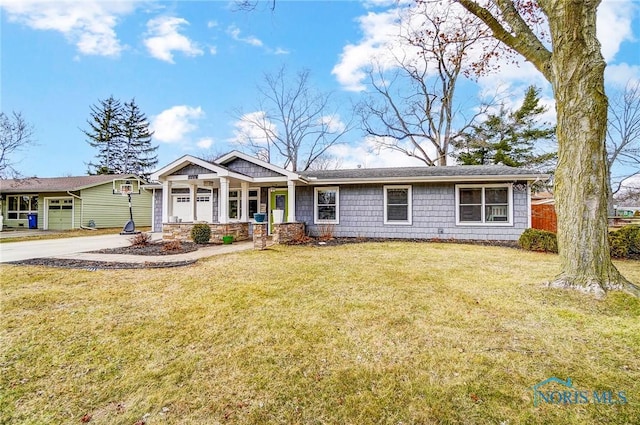 view of front of home with concrete driveway and a front yard