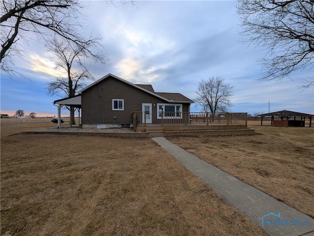 exterior space with a front yard and a wooden deck