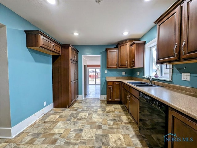 kitchen with a sink, a wealth of natural light, baseboards, and dishwasher