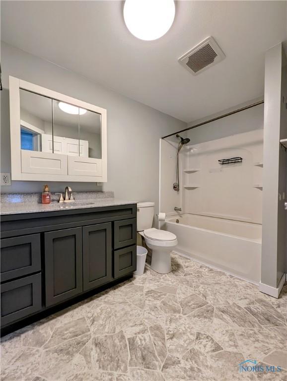 full bath featuring visible vents, toilet, vanity, and shower / tub combination