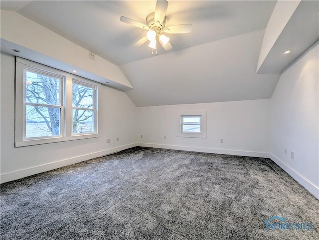 additional living space featuring carpet floors, lofted ceiling, ceiling fan, and baseboards