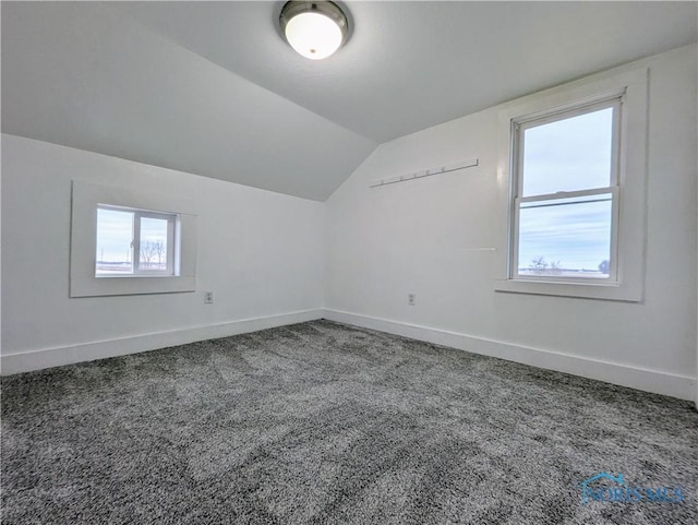 bonus room with carpet floors, lofted ceiling, and baseboards