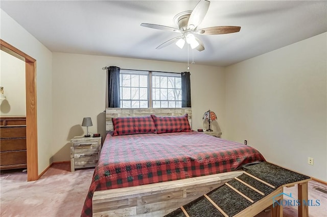 carpeted bedroom featuring a ceiling fan, visible vents, and baseboards