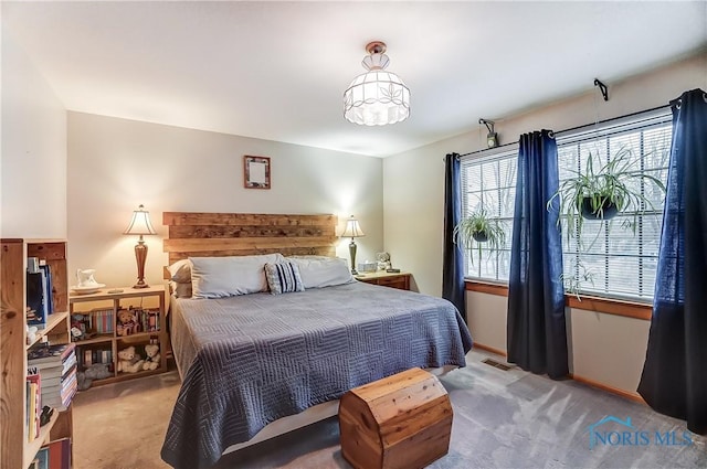 bedroom featuring light carpet, baseboards, and visible vents