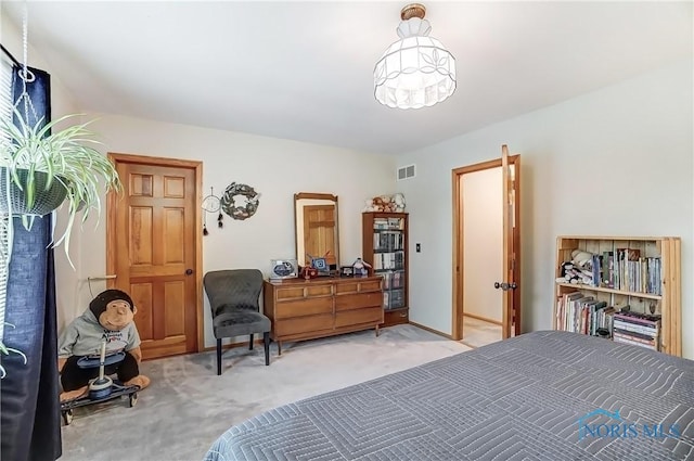 bedroom featuring visible vents and light colored carpet