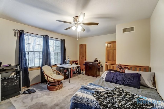 carpeted bedroom with visible vents and ceiling fan