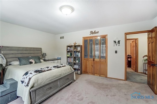 bedroom featuring light carpet, visible vents, and baseboards