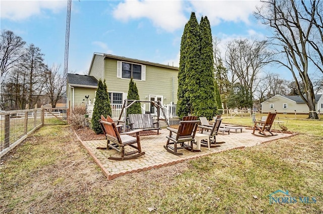 back of house with a fire pit, a lawn, a patio area, and fence