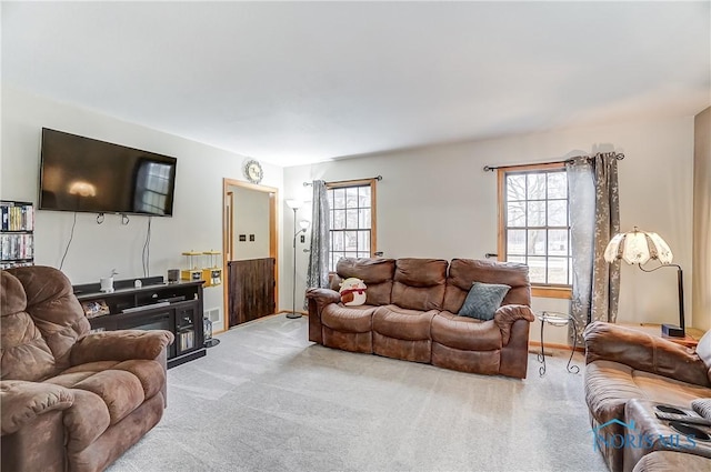 living room featuring light carpet and a healthy amount of sunlight