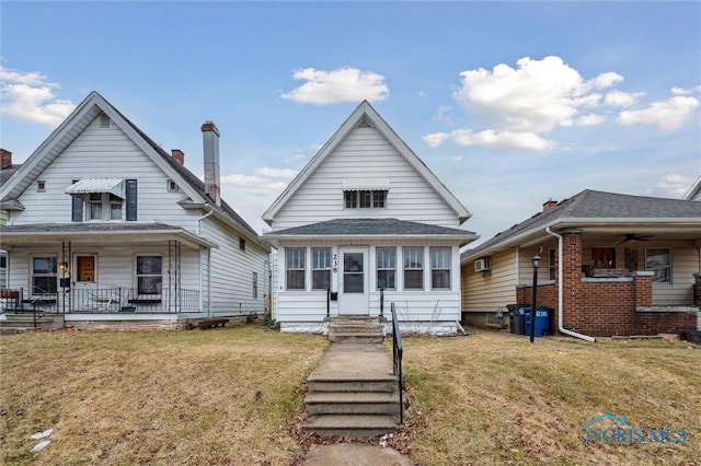 bungalow with covered porch, a front yard, and entry steps