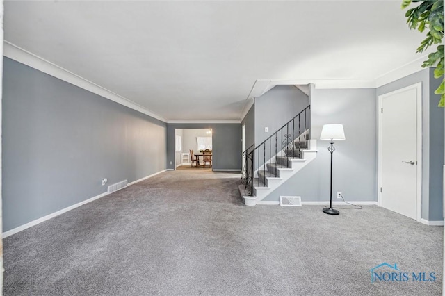 unfurnished living room with stairs, ornamental molding, visible vents, and baseboards