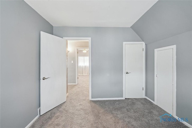 unfurnished bedroom with carpet flooring and baseboards