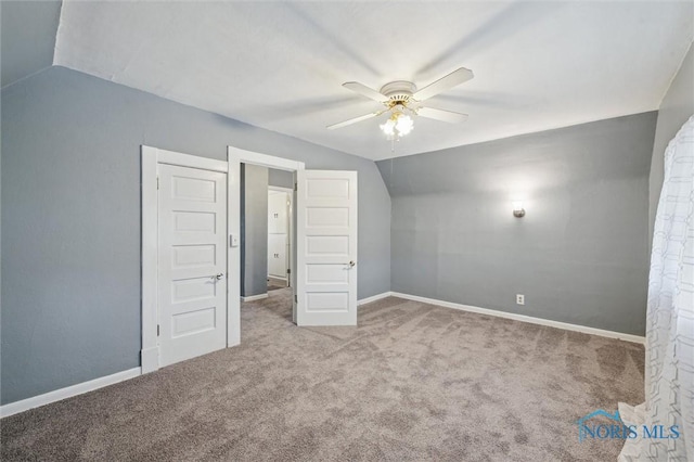 additional living space featuring carpet, vaulted ceiling, baseboards, and ceiling fan