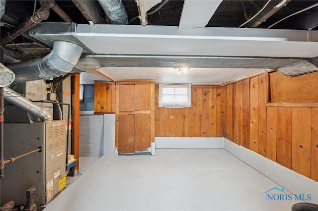 below grade area with heating unit and wooden walls