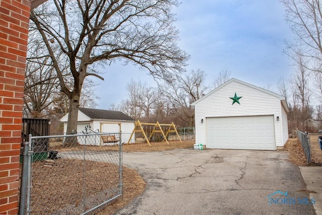 detached garage featuring fence