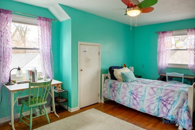 bedroom featuring baseboards and wood finished floors