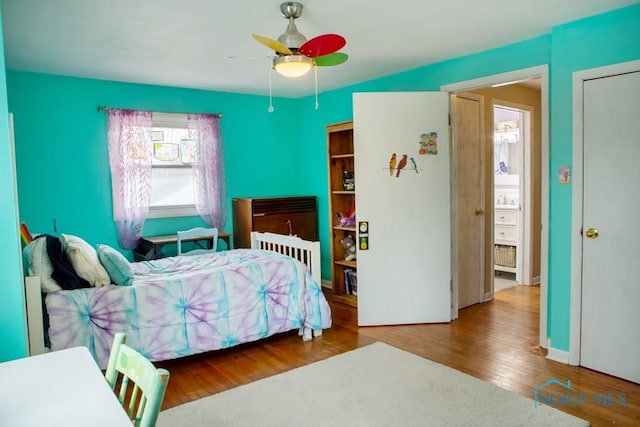 bedroom with a ceiling fan and wood finished floors