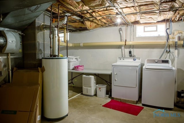 clothes washing area with water heater, laundry area, and washing machine and dryer