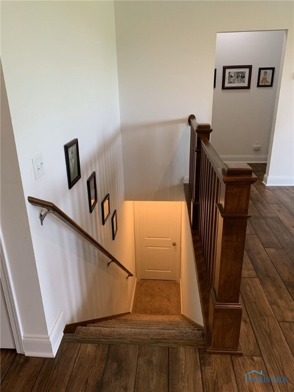 stairs with baseboards and wood finished floors