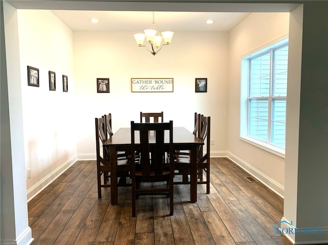 dining room with recessed lighting, dark wood finished floors, baseboards, and an inviting chandelier