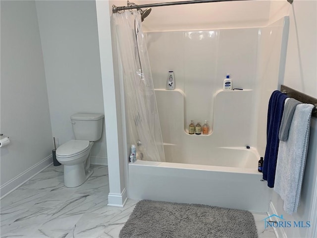 full bathroom featuring shower / tub combo, marble finish floor, baseboards, and toilet