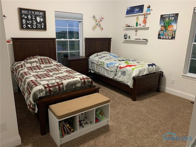 carpeted bedroom featuring baseboards