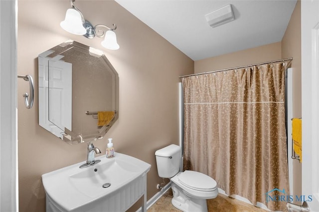 full bath featuring a shower with curtain, vanity, toilet, and tile patterned floors