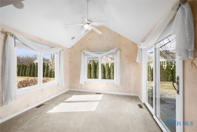 spare room with carpet floors, visible vents, and vaulted ceiling