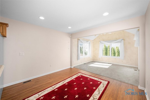 interior space featuring baseboards, wood finished floors, and recessed lighting