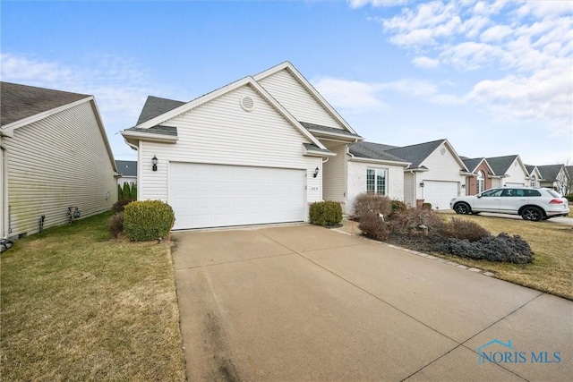 view of front of home with driveway, a garage, and a front yard