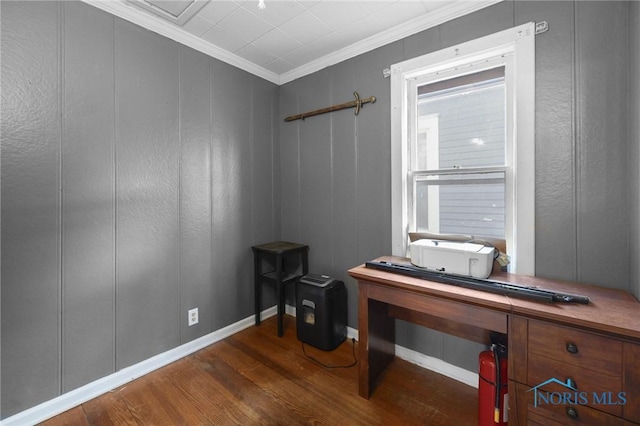 misc room featuring crown molding, a decorative wall, and wood finished floors