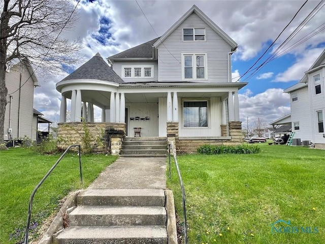 view of front of property featuring a front yard, covered porch, and roof with shingles