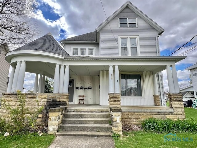 view of front of house with a shingled roof and a porch