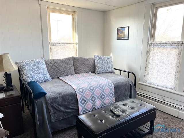 bedroom with carpet floors and baseboard heating