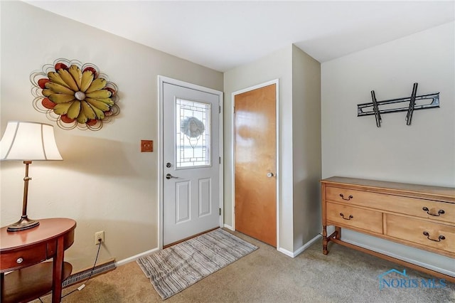 foyer featuring carpet and baseboards