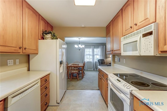 kitchen featuring white appliances, light colored carpet, light countertops, and an inviting chandelier