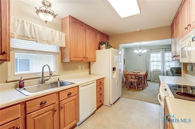 kitchen with light countertops, white appliances, a sink, and light colored carpet