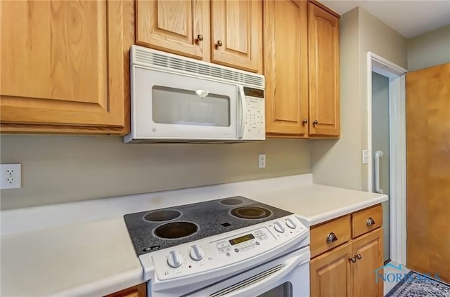 kitchen featuring light countertops and white appliances