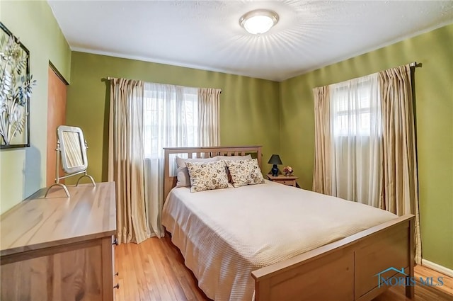 bedroom with light wood-type flooring